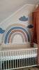 Installation of a dark blue rainbow wall decal
